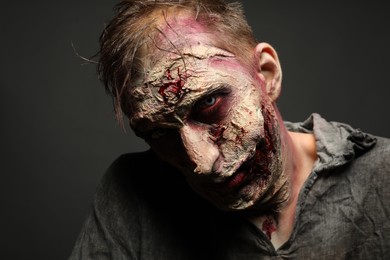 Scary zombie on dark background. Halloween monster
