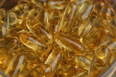 Many yellow capsules as background, closeup view