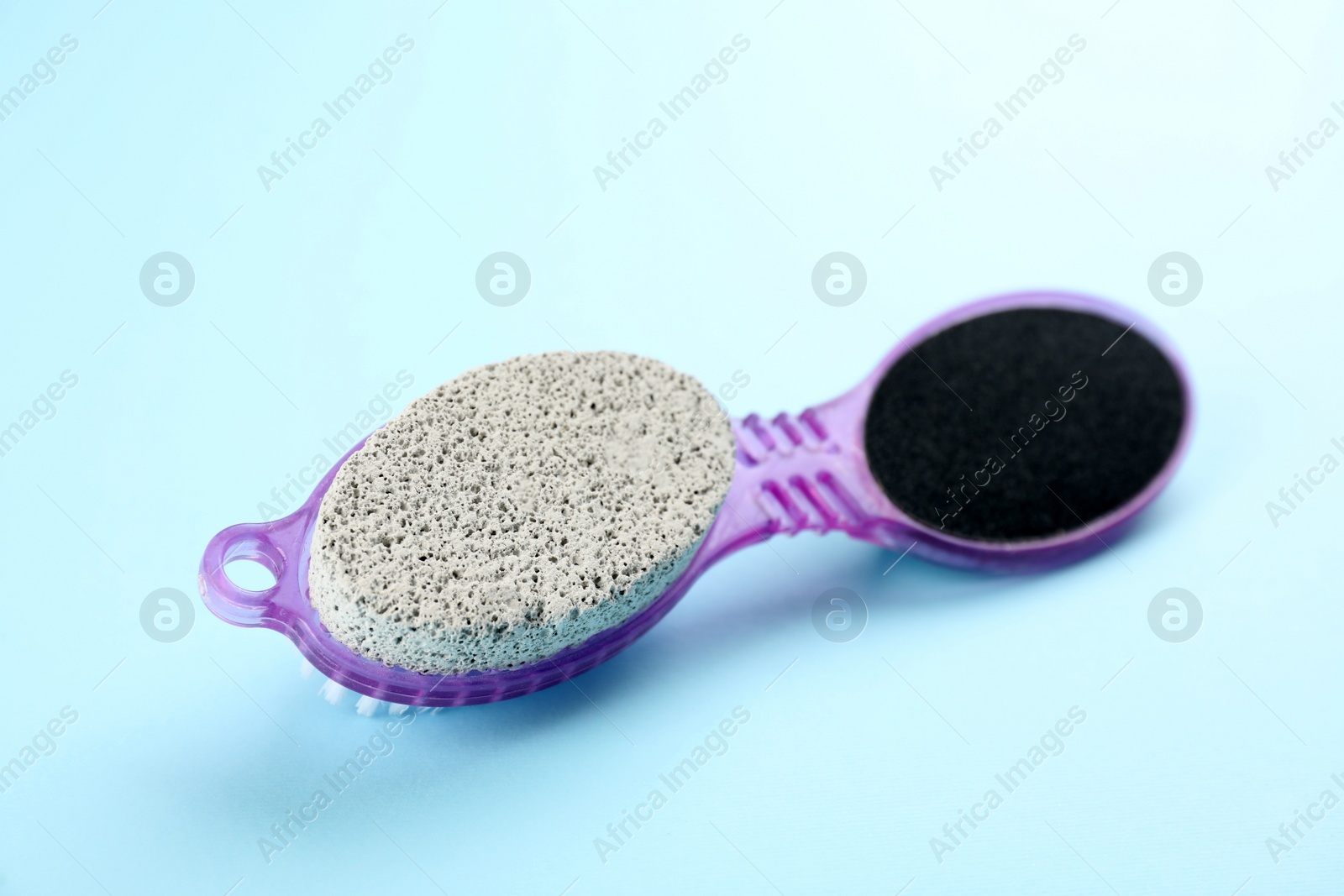 Photo of Pedicure tool with pumice stone and foot file on light blue background