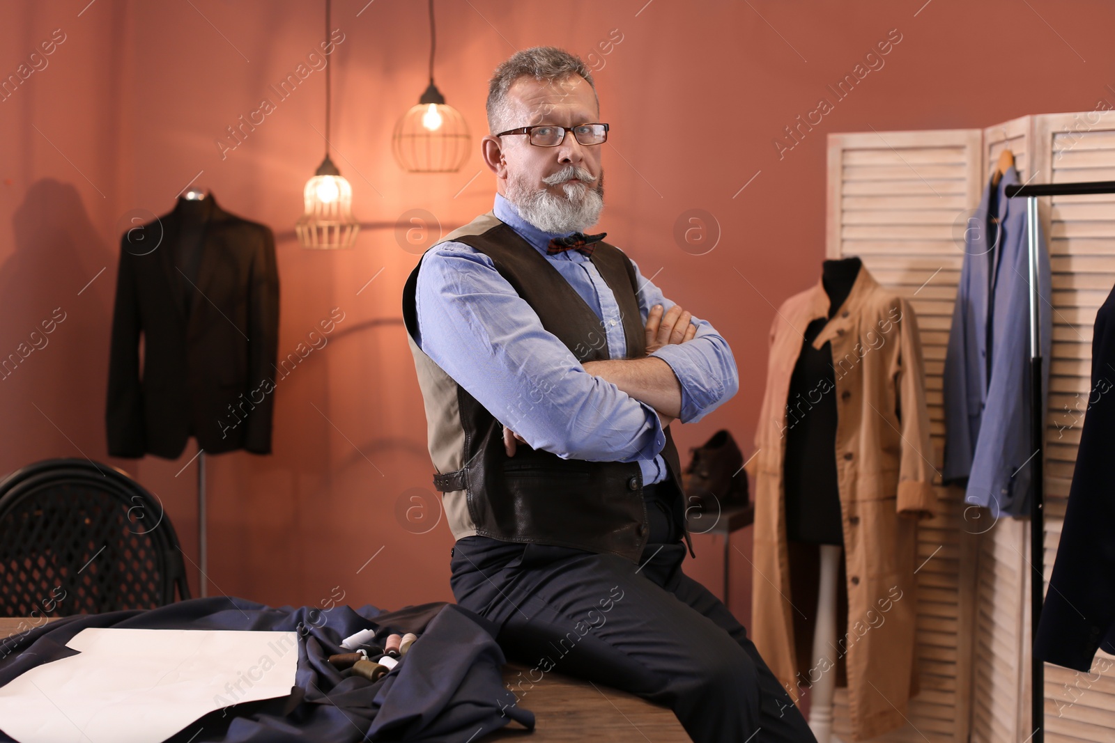 Photo of Portrait of mature tailor in atelier