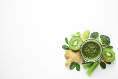 Delicious green juice and fresh ingredients on white background, top view