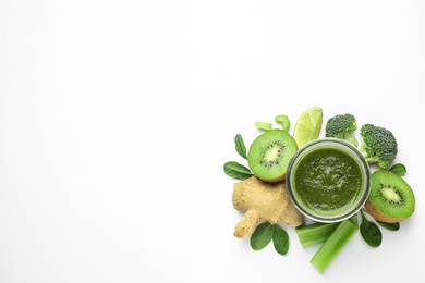 Photo of Delicious green juice and fresh ingredients on white background, top view