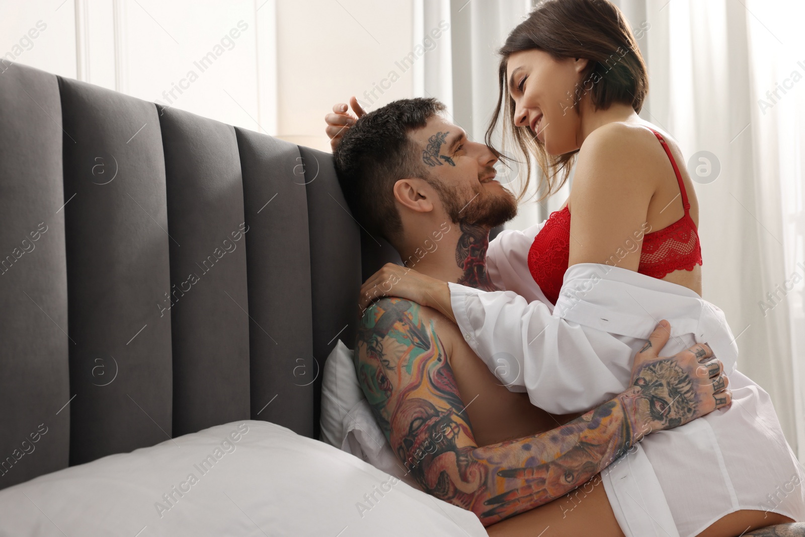 Photo of Passionate couple having sex on bed at home