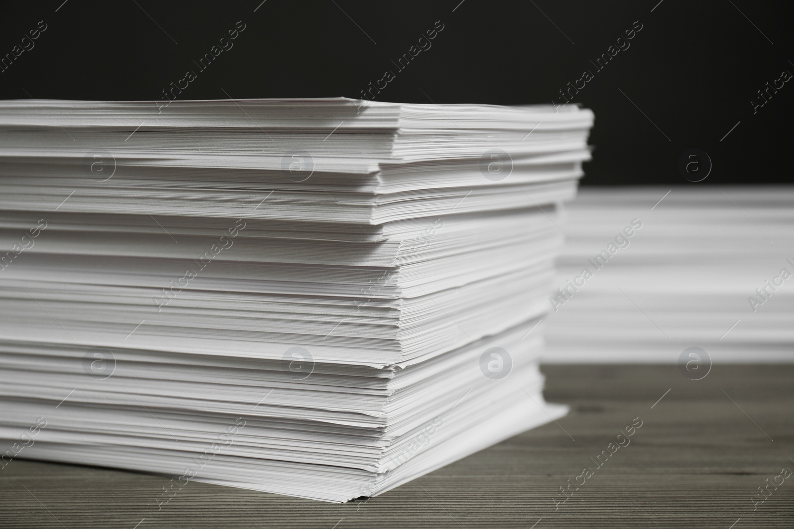 Photo of Stack of paper sheets on wooden table, closeup