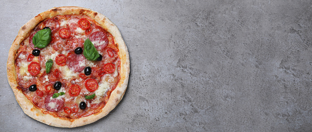 Image of Top viewhot delicious pizza on grey table, space for text. Banner design 