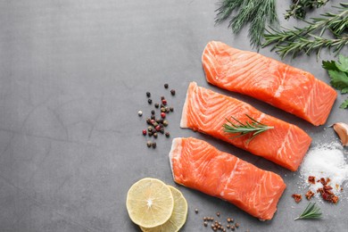 Photo of Fresh salmon and ingredients for marinade on grey table, flat lay. Space for text