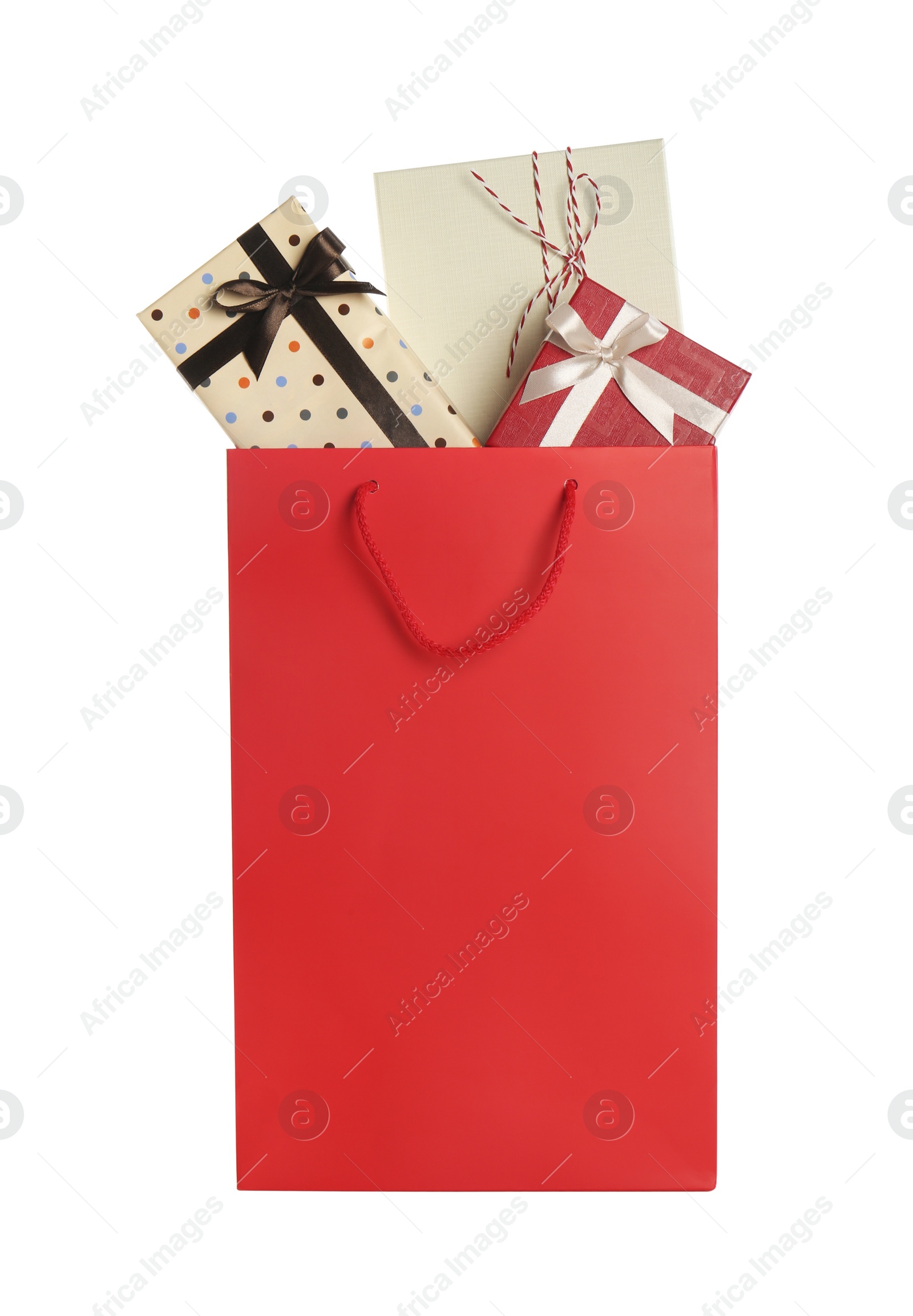 Photo of Paper shopping bag full of gift boxes isolated on white