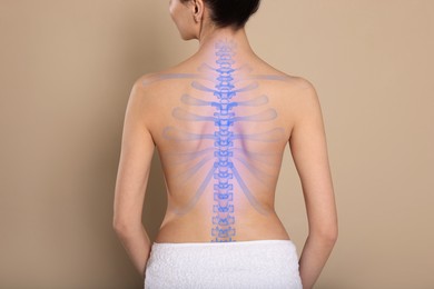 Woman with healthy spine on beige background, back view