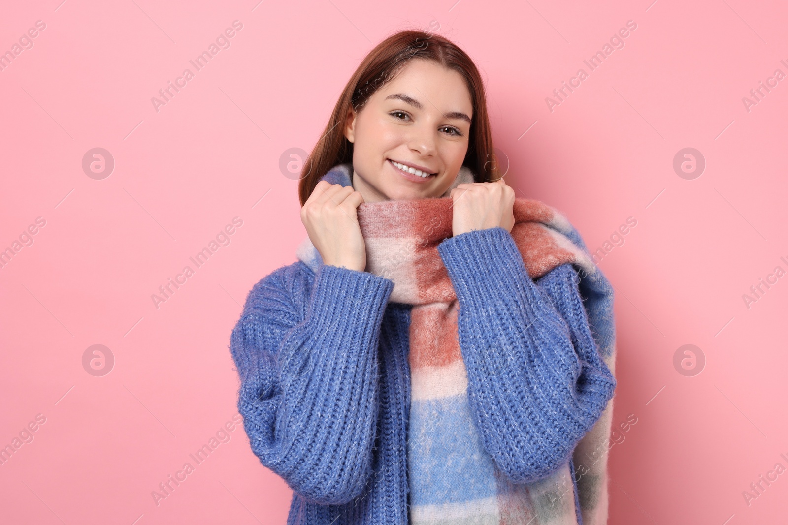 Photo of Beautiful woman in warm scarf on pink background