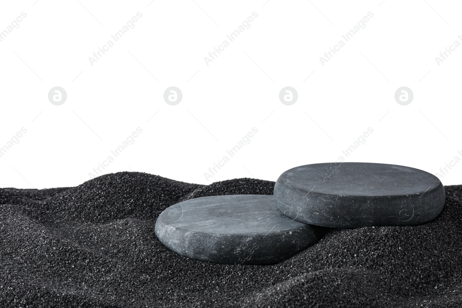 Photo of Presentation of product. Stone podiums on black sand against white background