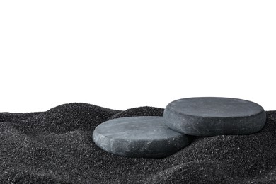 Photo of Presentation of product. Stone podiums on black sand against white background