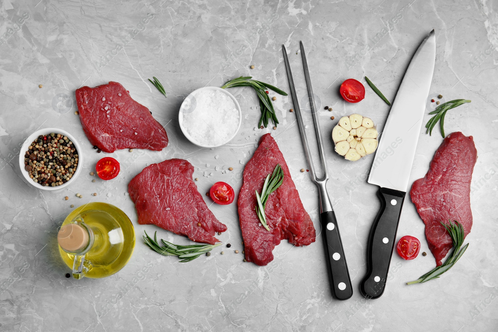 Photo of Fresh raw meat steaks and spices on light grey table, flat lay