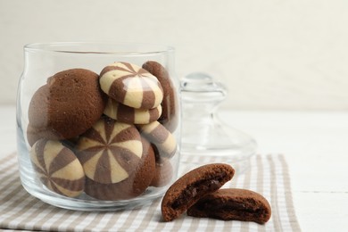 Photo of Sweet delicious cookies in glass jar on table