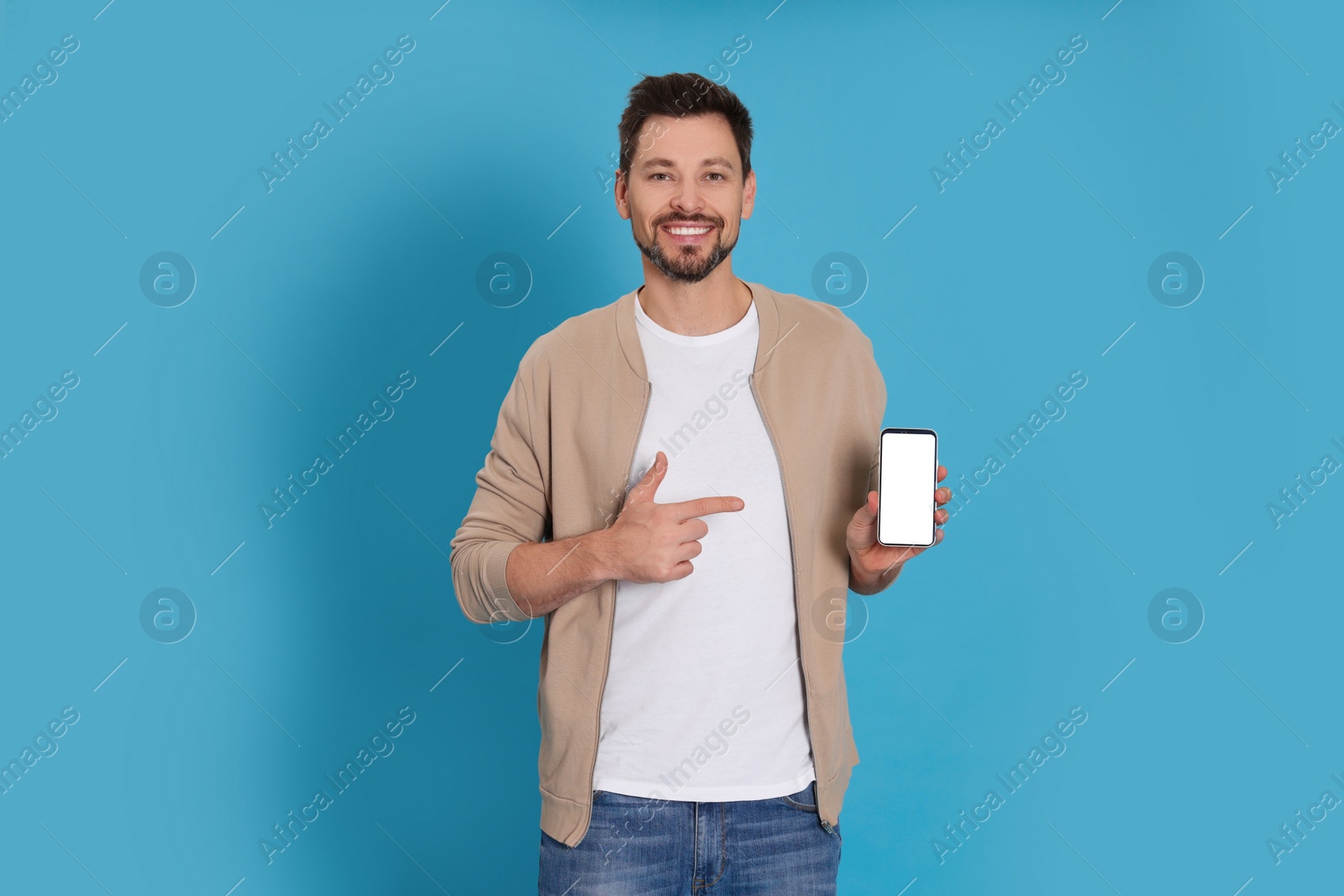 Photo of Happy man with phone on light blue background