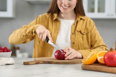 Woman preparing ingredients for tasty smoothie at white marble table in kitchen, closeup