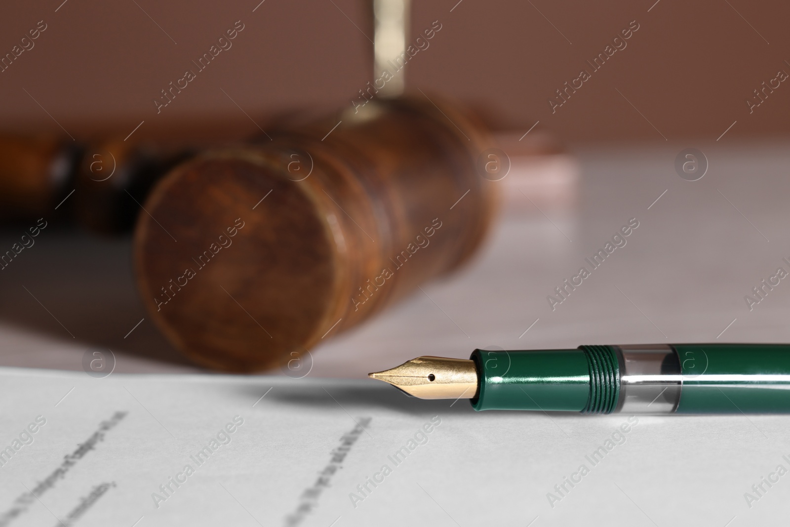 Photo of Fountain pen and paper document on table, closeup with space for text. Notary service