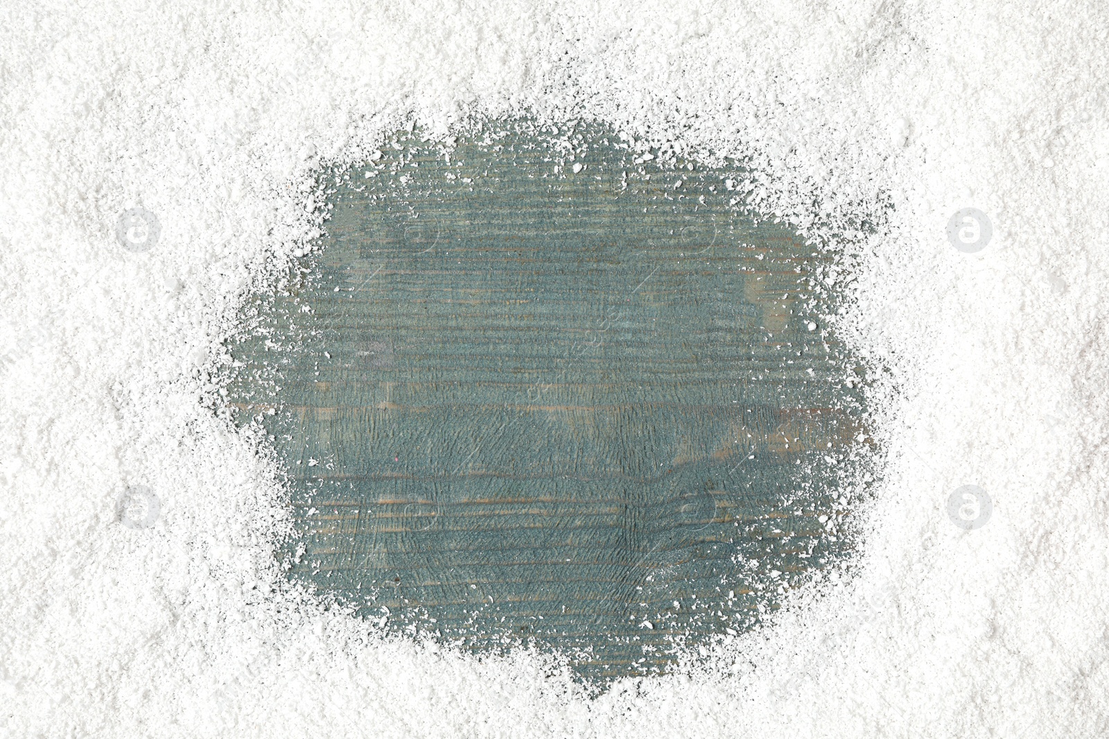 Photo of Frame made of artificial snow on blue wooden background, top view with space for text. Christmas decor