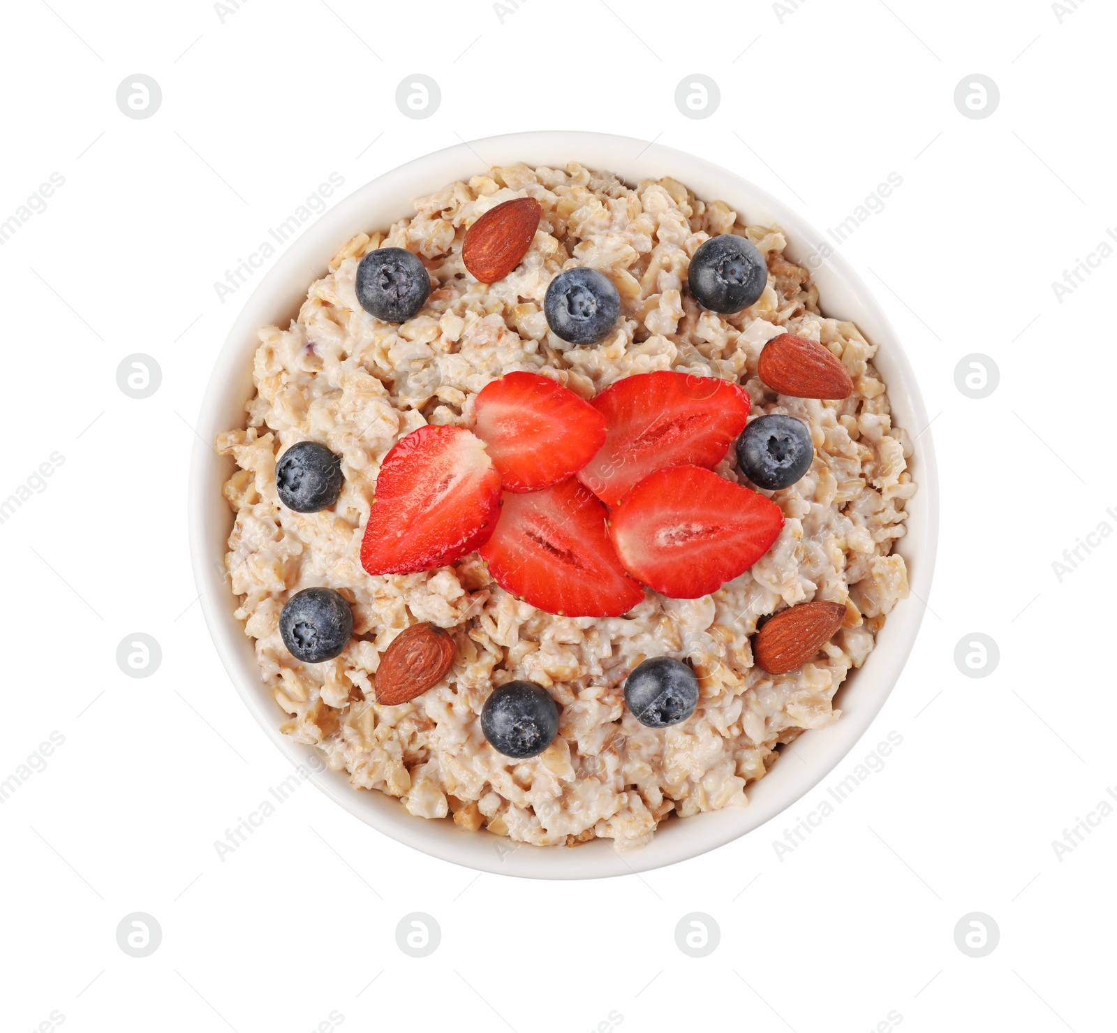 Photo of Tasty boiled oatmeal with berries and almonds in bowl isolated on white, top view