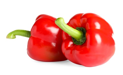 Photo of Tasty ripe red bell peppers on white background