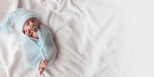 Cute newborn baby sleeping on white plaid, top view with space for text. Banner design