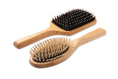 Photo of New wooden hair brushes isolated on white