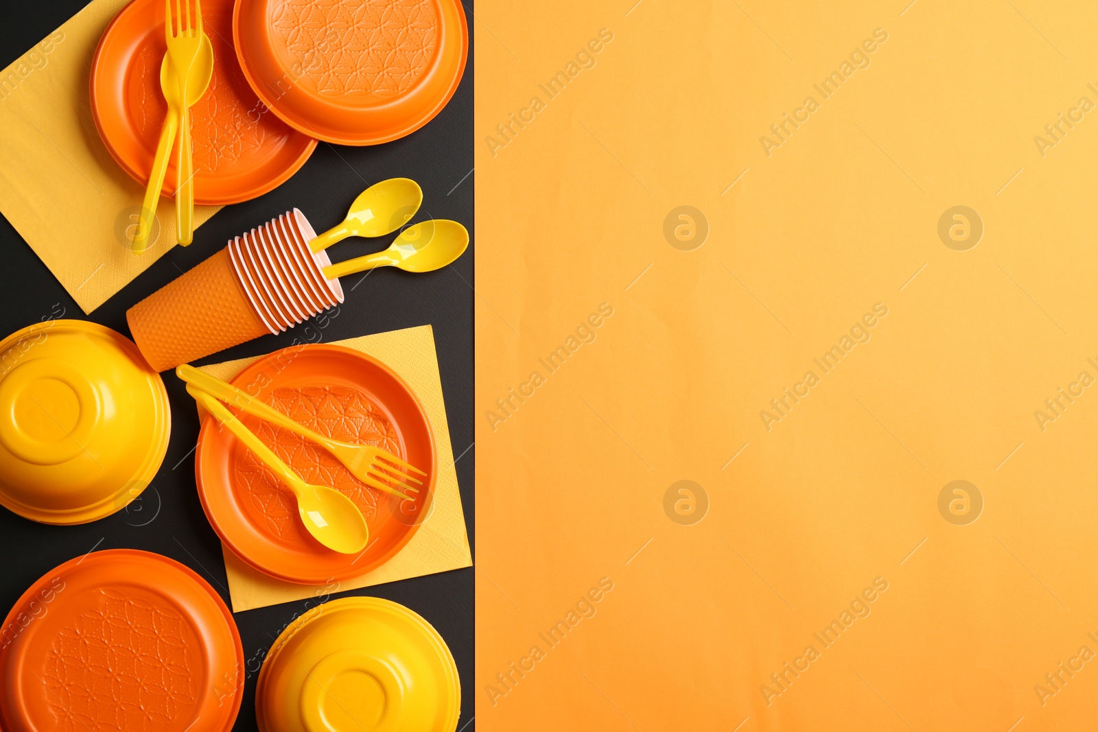 Photo of New plastic dishware and space for text on color background. Table setting