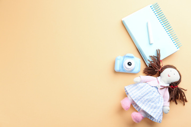 Flat lay composition with little photographer's toy camera on beige background. Space for text