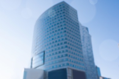 Blurred view of modern buildings on sunny day