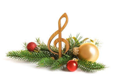 Wooden treble clef and decorations on white background. Christmas music concept