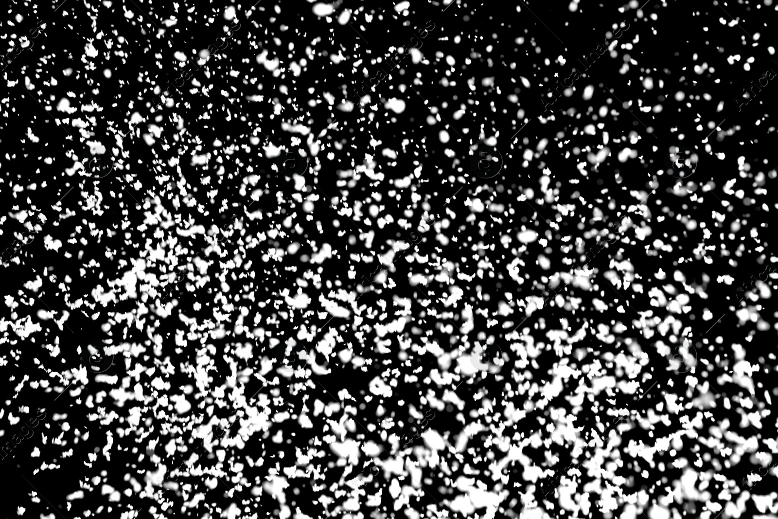 Photo of White snow falling down on black background