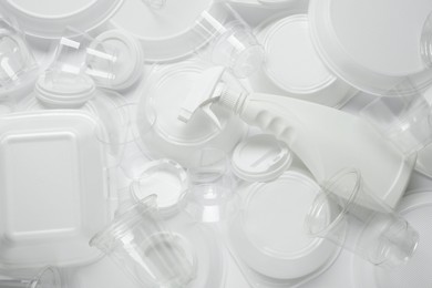 Photo of Different white plastic items as background, closeup