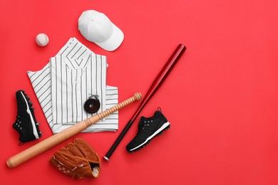Photo of Flat lay composition with baseball uniform and sports equipment on red background. Space for text