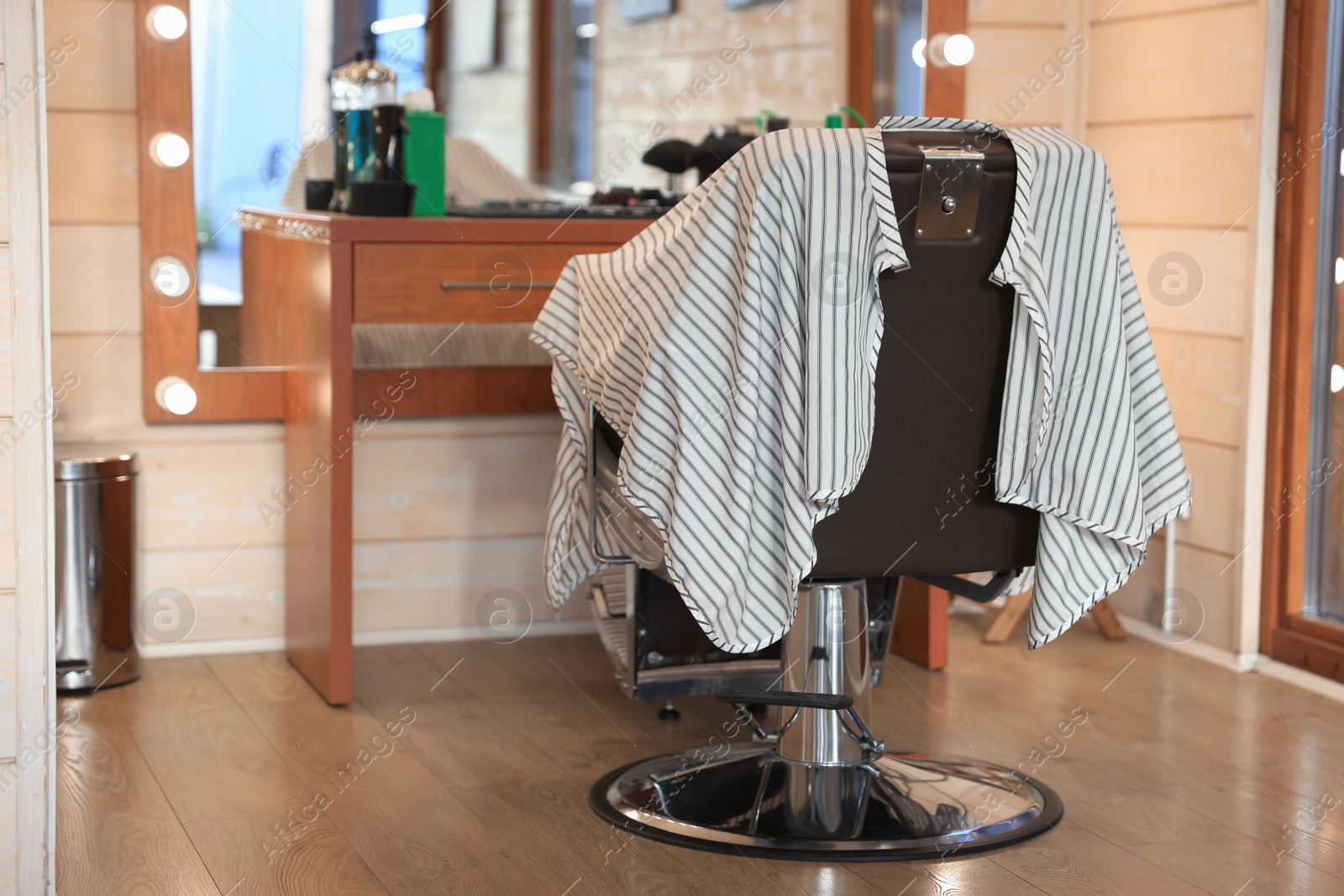 Photo of Stylish hairdresser's workplace with professional armchair in barbershop