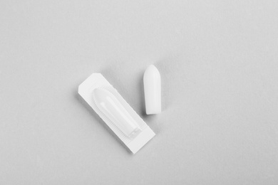 Suppositories on light background, flat lay. Hemorrhoid treatment