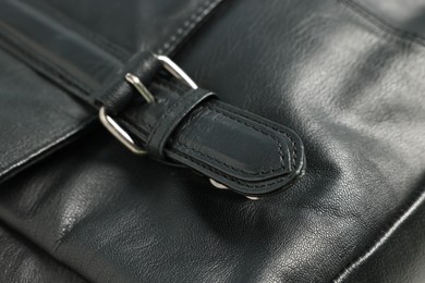 Photo of Black natural leather with buckle as background, closeup
