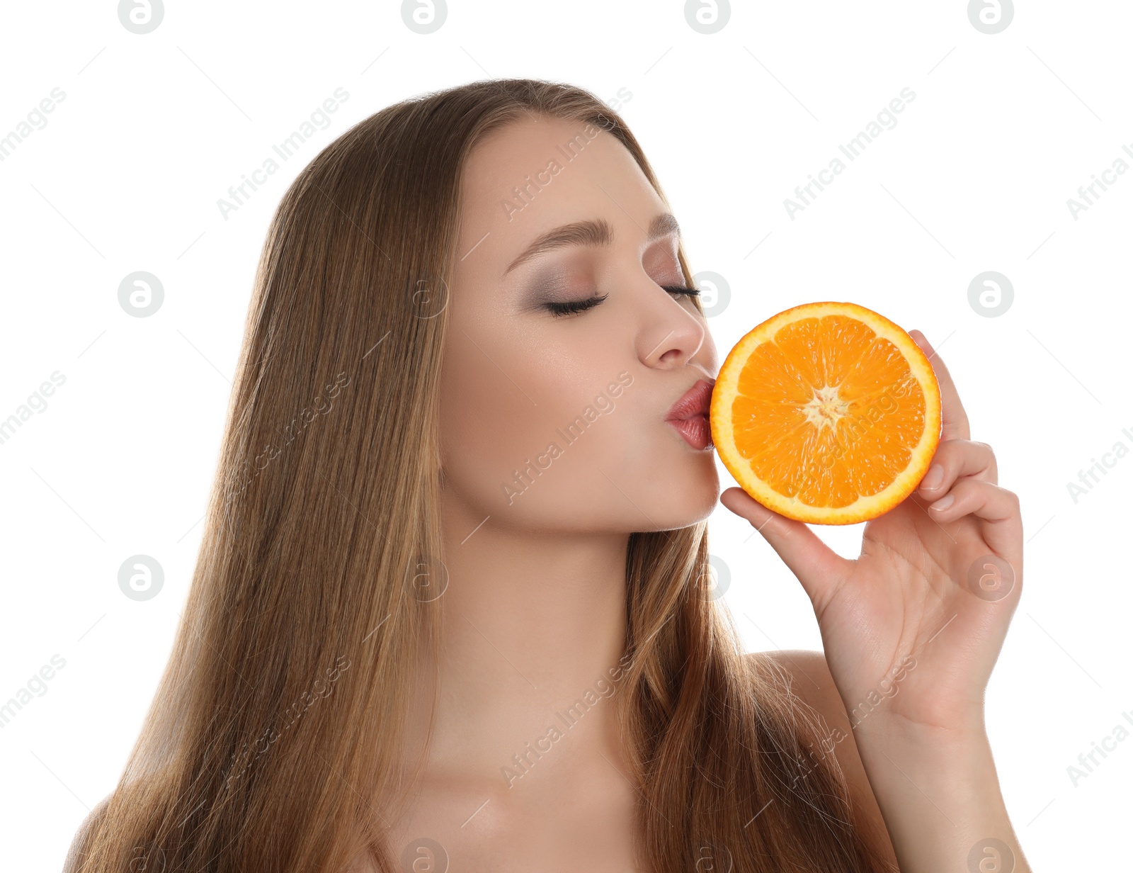 Photo of Young woman with cut orange on white background. Vitamin rich food