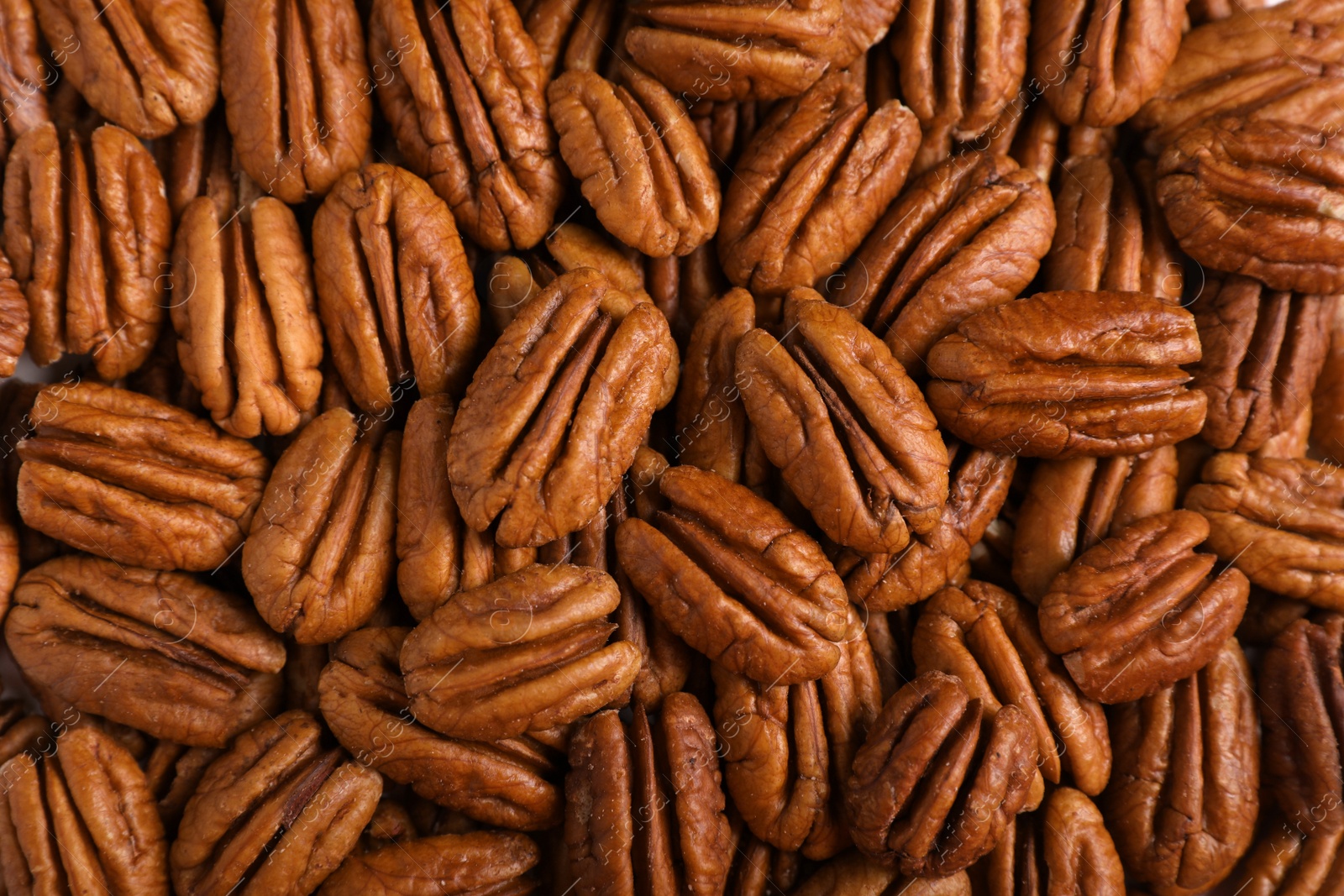 Photo of Tasty fresh ripe pecan nuts as background, top view