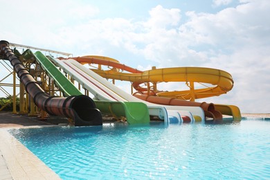 Beautiful view of water park with colorful slides and swimming pool on sunny day
