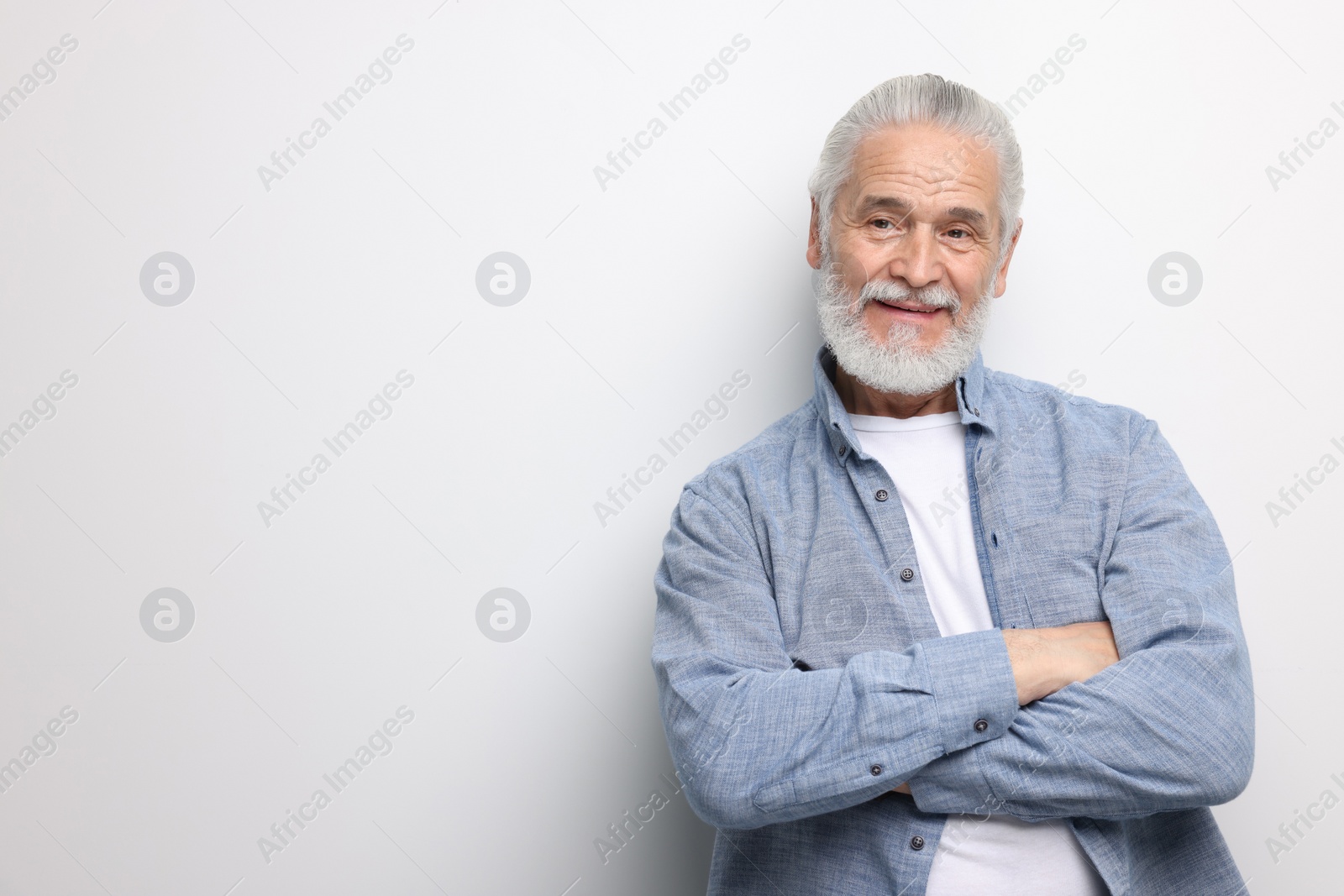 Photo of Portrait of handsome senior man on white background. Space for text