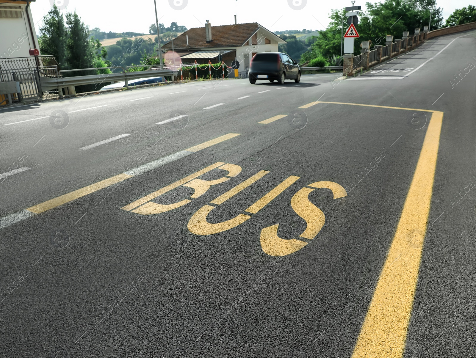 Photo of Bus stop pad on asphalt road on sunny day