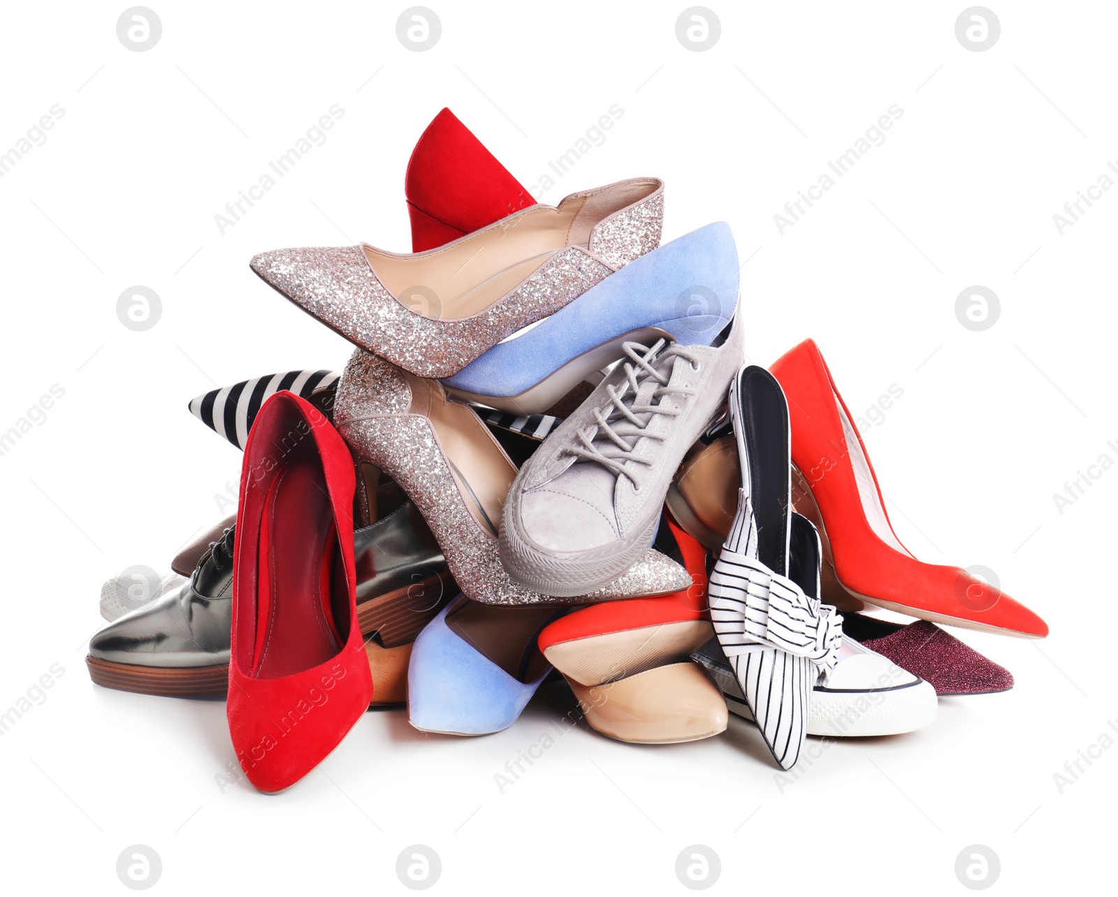 Photo of Pile of female shoes on white background