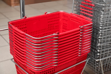 Stack of empty shopping baskets in supermarket, closeup