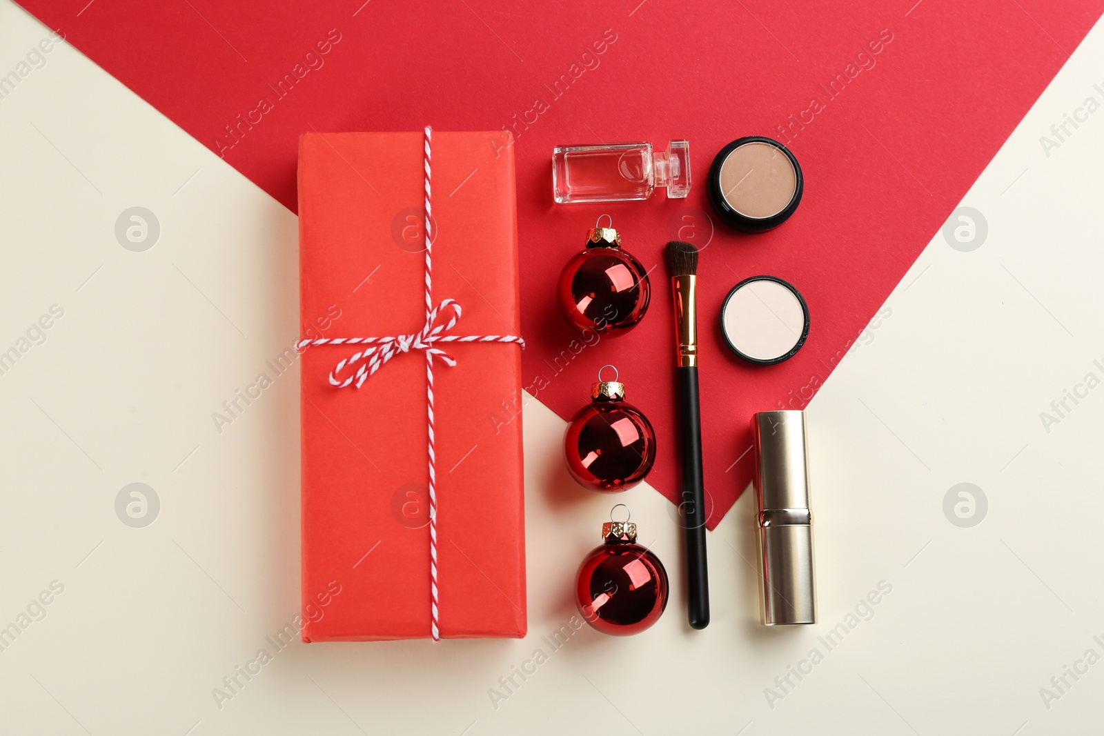 Photo of Flat lay composition with decorative cosmetic products on color background. Winter care