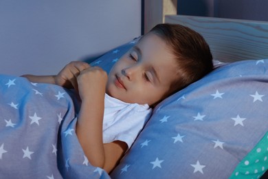 Photo of Cute little boy sleeping in comfortable bed