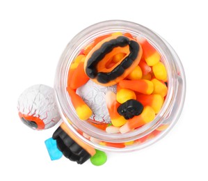 Jar of delicious colorful candies isolated on white, top view. Halloween sweets