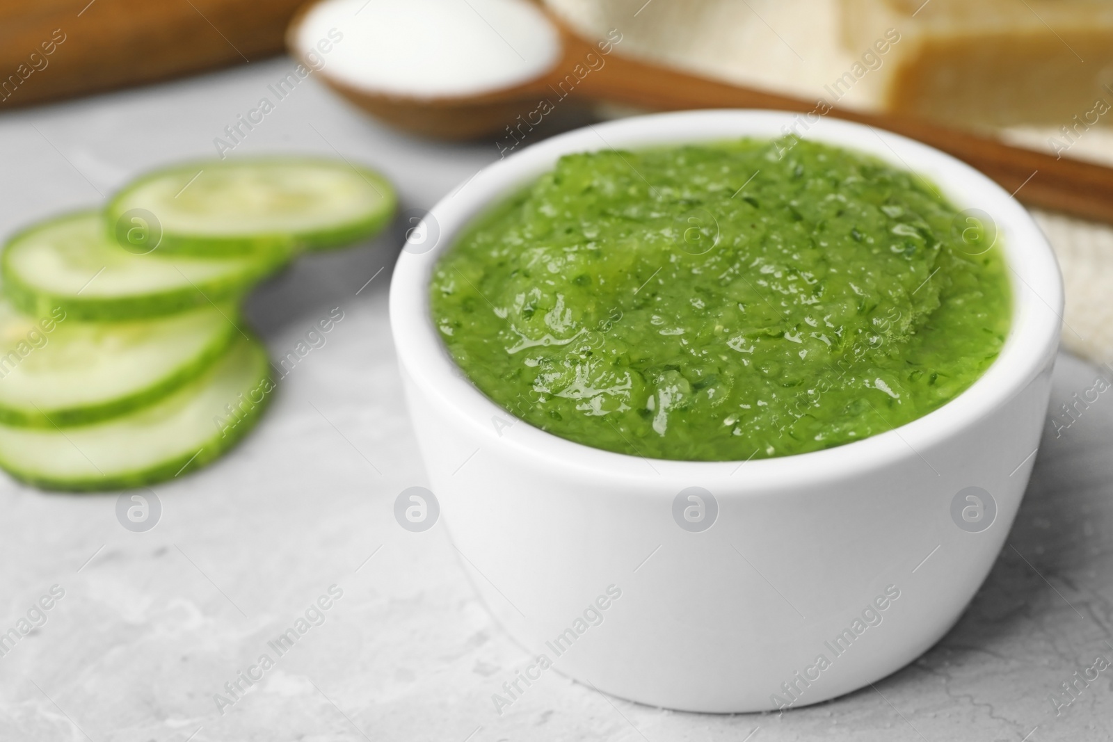 Photo of Handmade face mask and ingredients on grey table