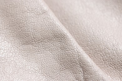 Photo of Beautiful beige leather as background, closeup view