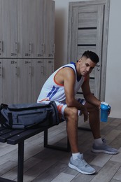 Handsome man with shaker in locker room