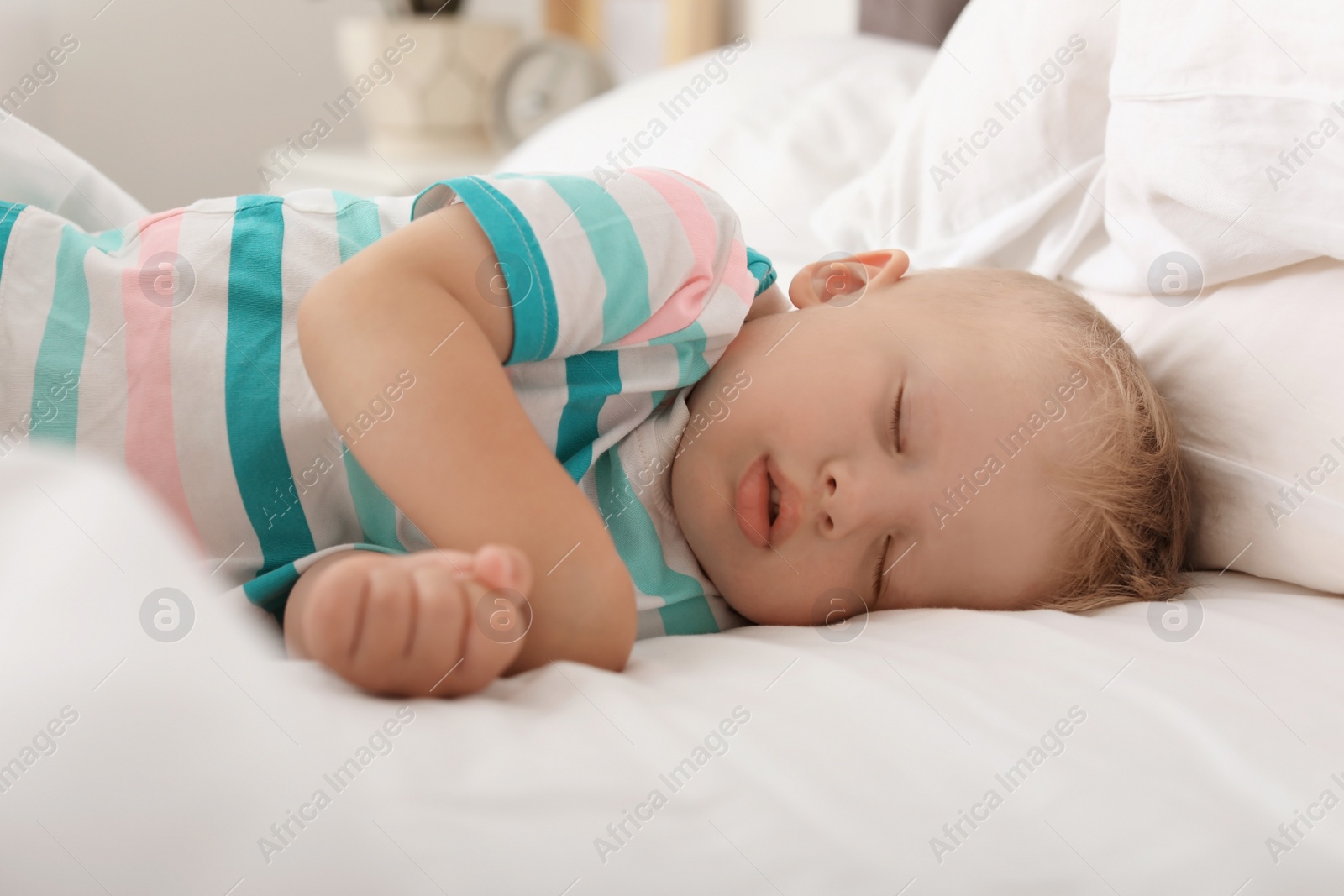 Photo of Little child sleeping in bed at home