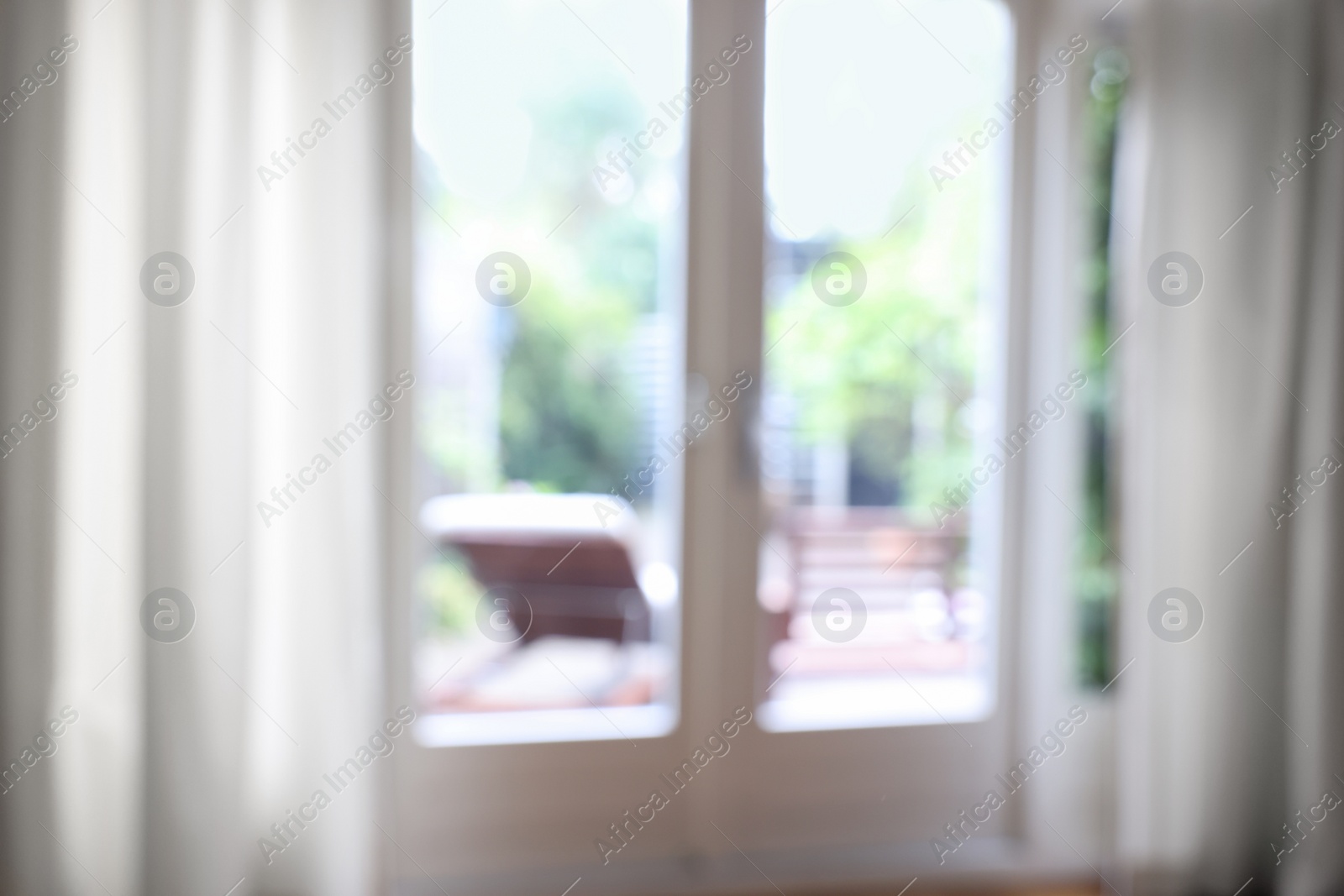 Photo of Blurred view of glass door at home